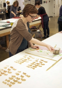 student painting fabric with dye