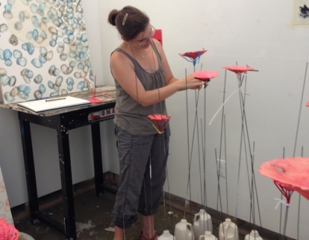 student building sculpture in studio