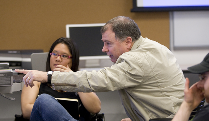 professor critiquing work in computer lab