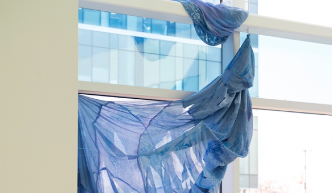 torn fabric hanging from window beams