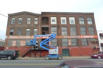 A bucket lift in from of the Photo Process sign