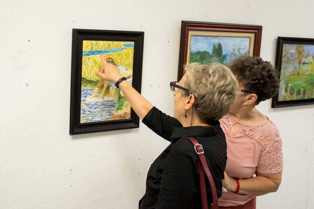 Attendees enjoy the art at the reception