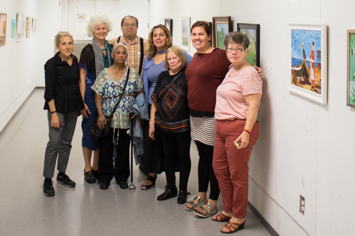 Attendees and artists pose for a photo together