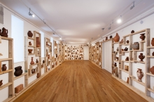 exhibition space with vessels on wall
