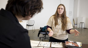 A student speaking with multiple pieces laid out in front of them