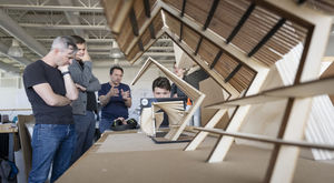 Architecture students and faculty reviewing prototypes for a design they created for the Southeast Asian Market at FDR Park in South Philadelphia