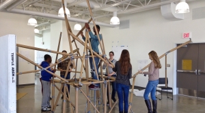 High school students working to build a structure out of cardboard and duct tape.