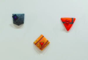 Installation view of colorful hanging shape artworks by Maxwell Davis