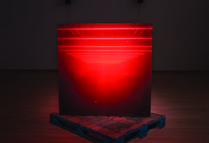 Glowing red large-print photograph, placed on top of a wooden pallet