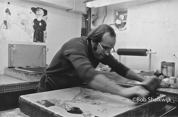 Andrew Vlady operating a stone lithograph machine