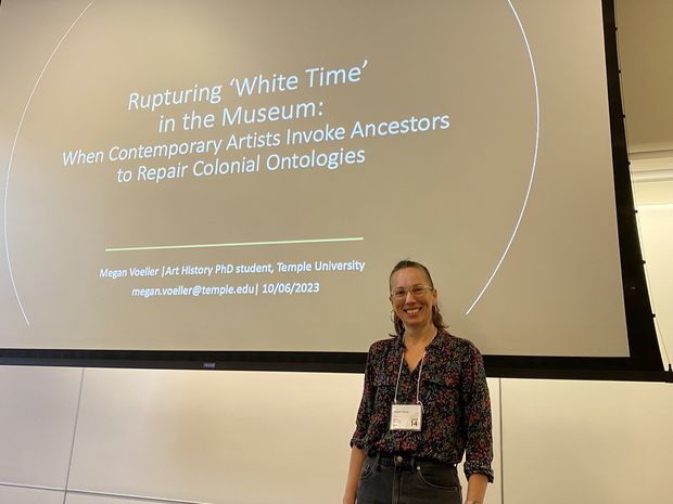 Megan Voeller standing in front of title slide