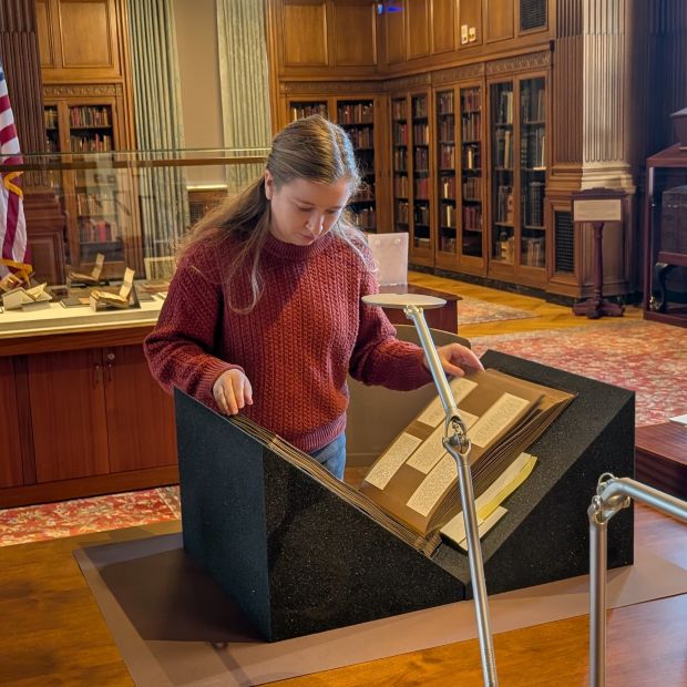 Emily Schollenberger examining a manuscript