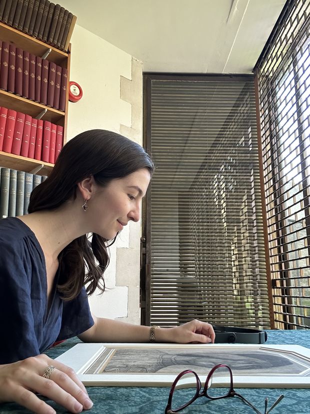 Emma P. Holter looking at a print