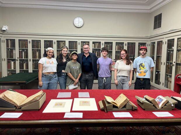 Joe Kopta with students, standing with materials