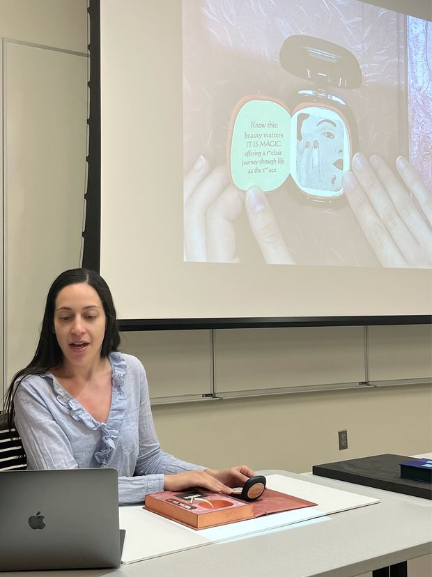 Rachel Vorsanger speaking in front of a screen