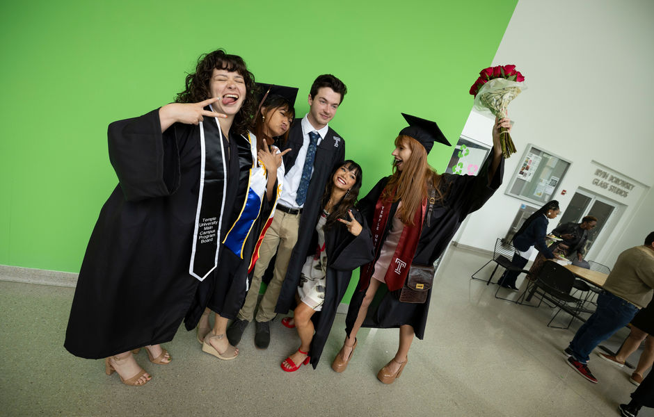 Five graduates pose together in Tyler's Green Hallway