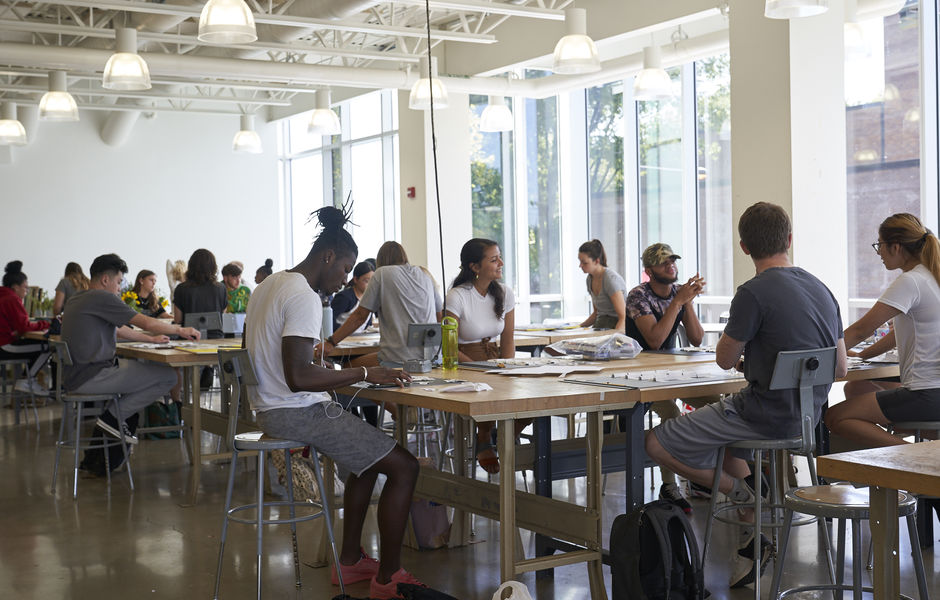 bright studio filled with working students