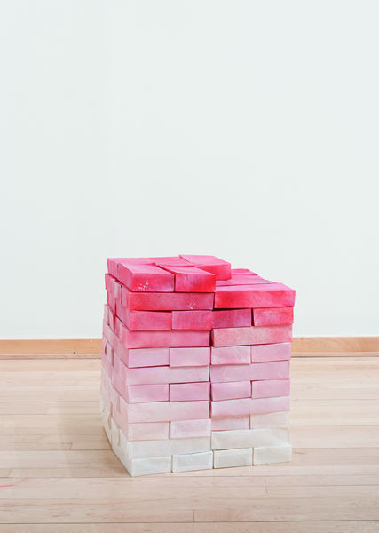 Gallery installation view of brick-like pink gradient fibers artwork by Anna Bockrath
