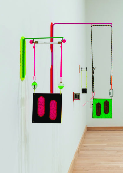 Gallery installation view of brightly colored hanging artwork by Maxwell Davis 
