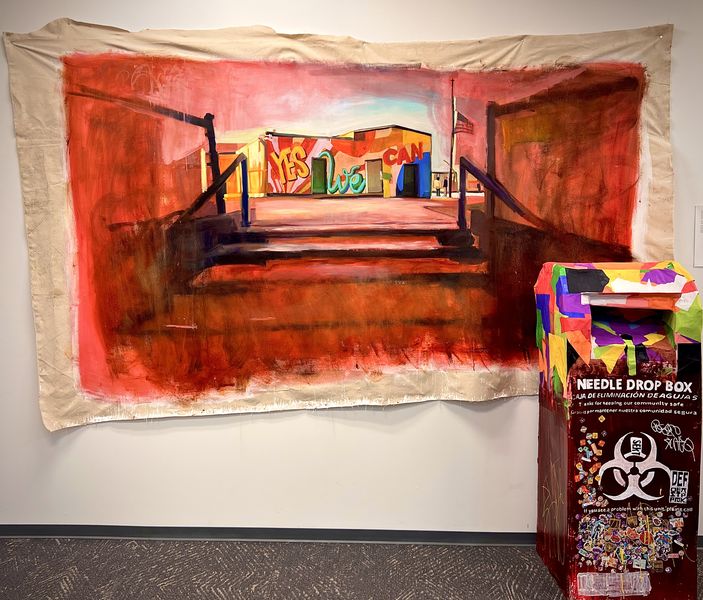 Large painting on a canvas tapestry of a red-hued staircase leading up to a building with a colorful mural painted on it that reads "Yes We Can"