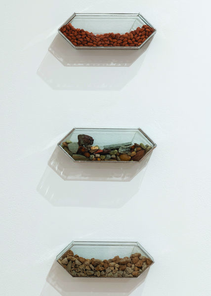 Three two pointed hexagonal boxes, each filled with various rocks