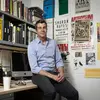 Portrait of Philip Glahn in his office leaning against his desk
