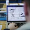 Student at a laptop working on an architectural design