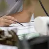Close up of a students hands drawing on an architectural plan