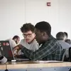Two students looking at a laptop.
