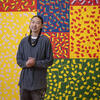 Artist Isaac Tin Wei Lin stands in front of a colorful installation in Temple Contemporary