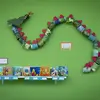 Elementary school art project of a dragon on display on a green wall
