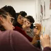 Group of students writing on a wall