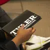 student holding a Tyler brochure