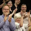 Faculty cheering and clapping in a crowd