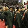 Tyler students walking in caps and gowns during the Commencement ceremony