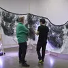 student and instructor discuss a sculpture piece