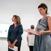 people in gallery reviewing information