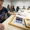 Students sitting at a table creating photographic prints