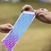 Hands holding up an abstract blue and purple print