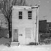 black and white photo of an abandoned building featured in the Funeral for a Home show
