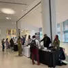 Career fair visitors and representatives in the Tyler atrium