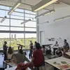 Instructor and students in Tyler painting studio with large windows