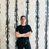 Portrait of Theodora Dagkli Andonopoulos in front of an artwork