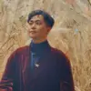 Portrait of Zixiao Huang standing in a field of tall grass