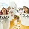 Tyler students holding up decorated t-shirts