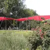 Image of a pavilion shelter with a red top in a grassy field