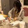 scholar works on assembling a glass project