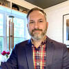 Portrait of Matthew Palczynski wearing a blazer and a plaid shirt