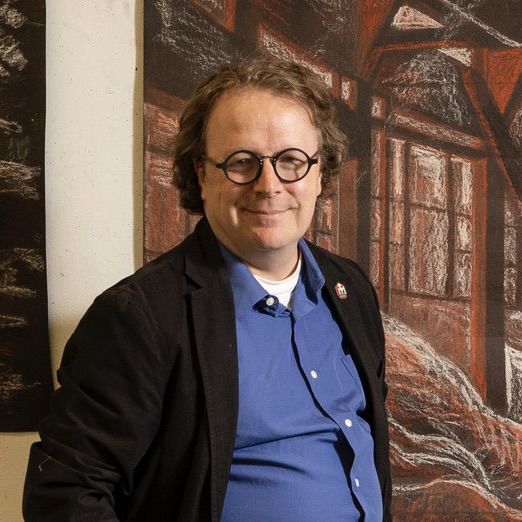 Gerard Brown sitting on a stool and looking at the camera.