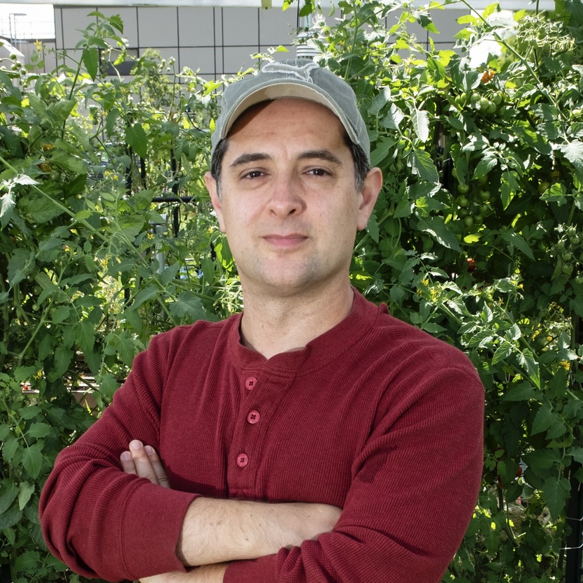 Joshua Caplan crossing his arms and looking at the camera.